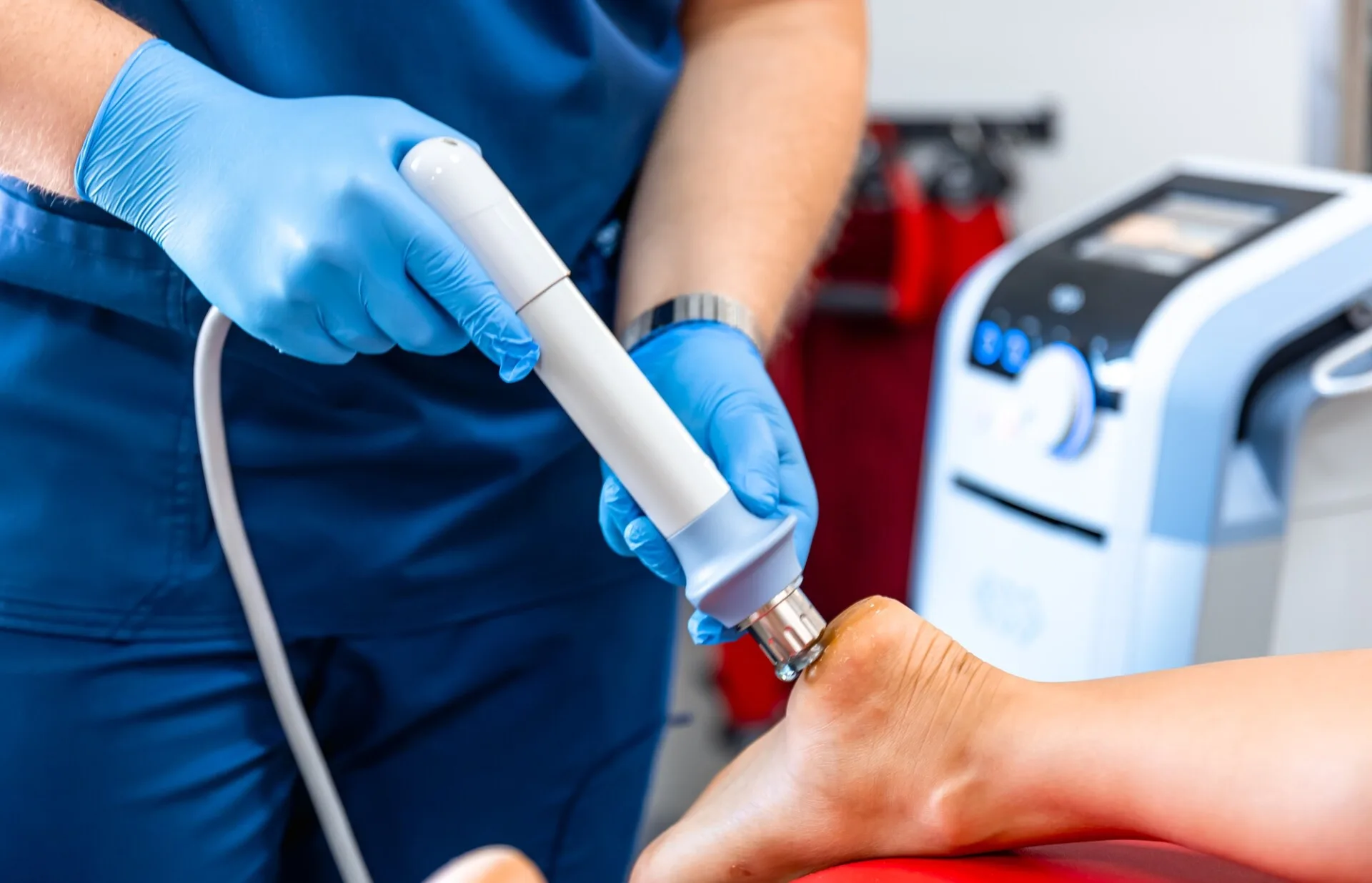 Physical therapy of foot with acoustic shock waves, close up.