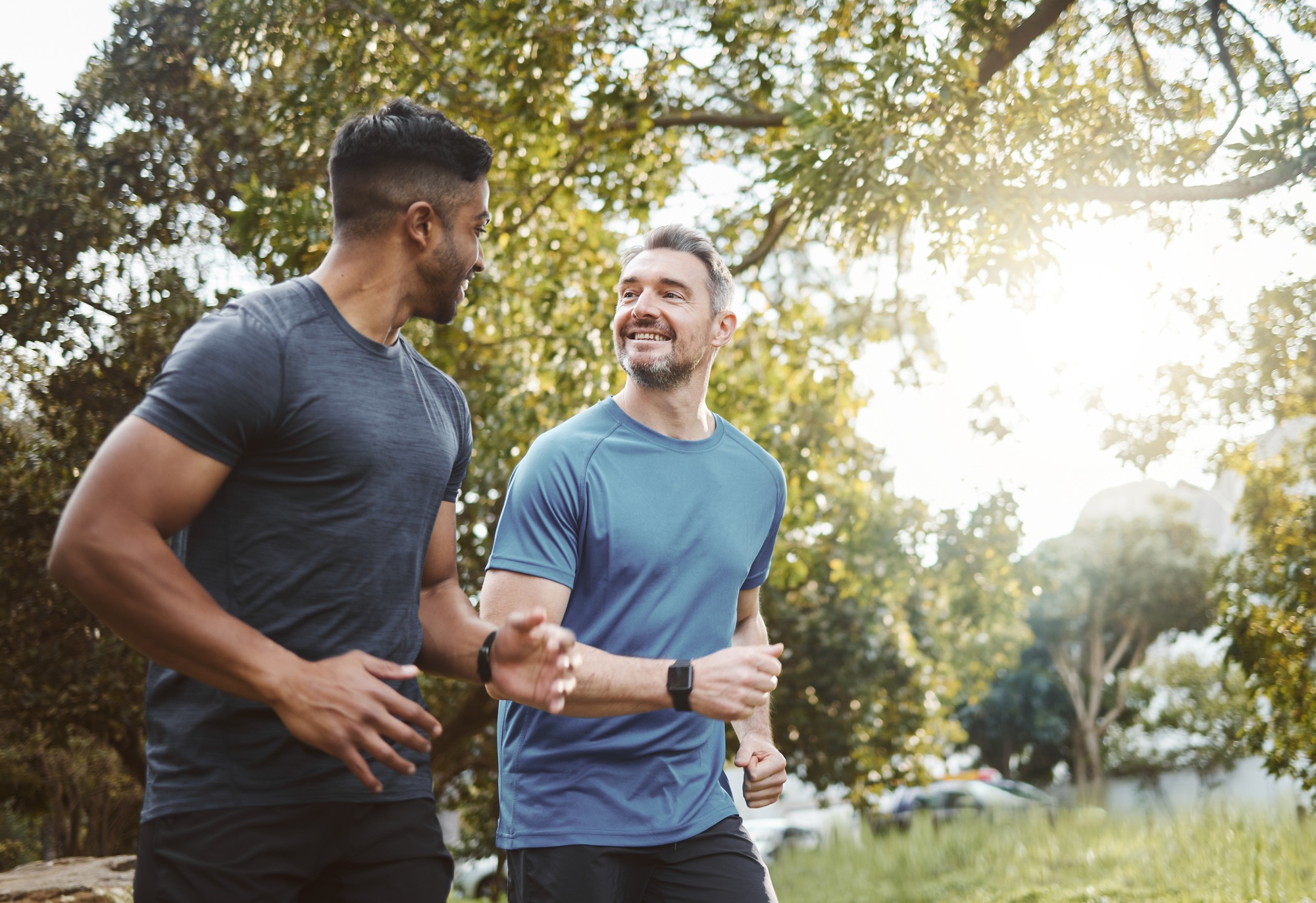 Running team, fitness and men in nature park with cardio, athlete and support for sports and health